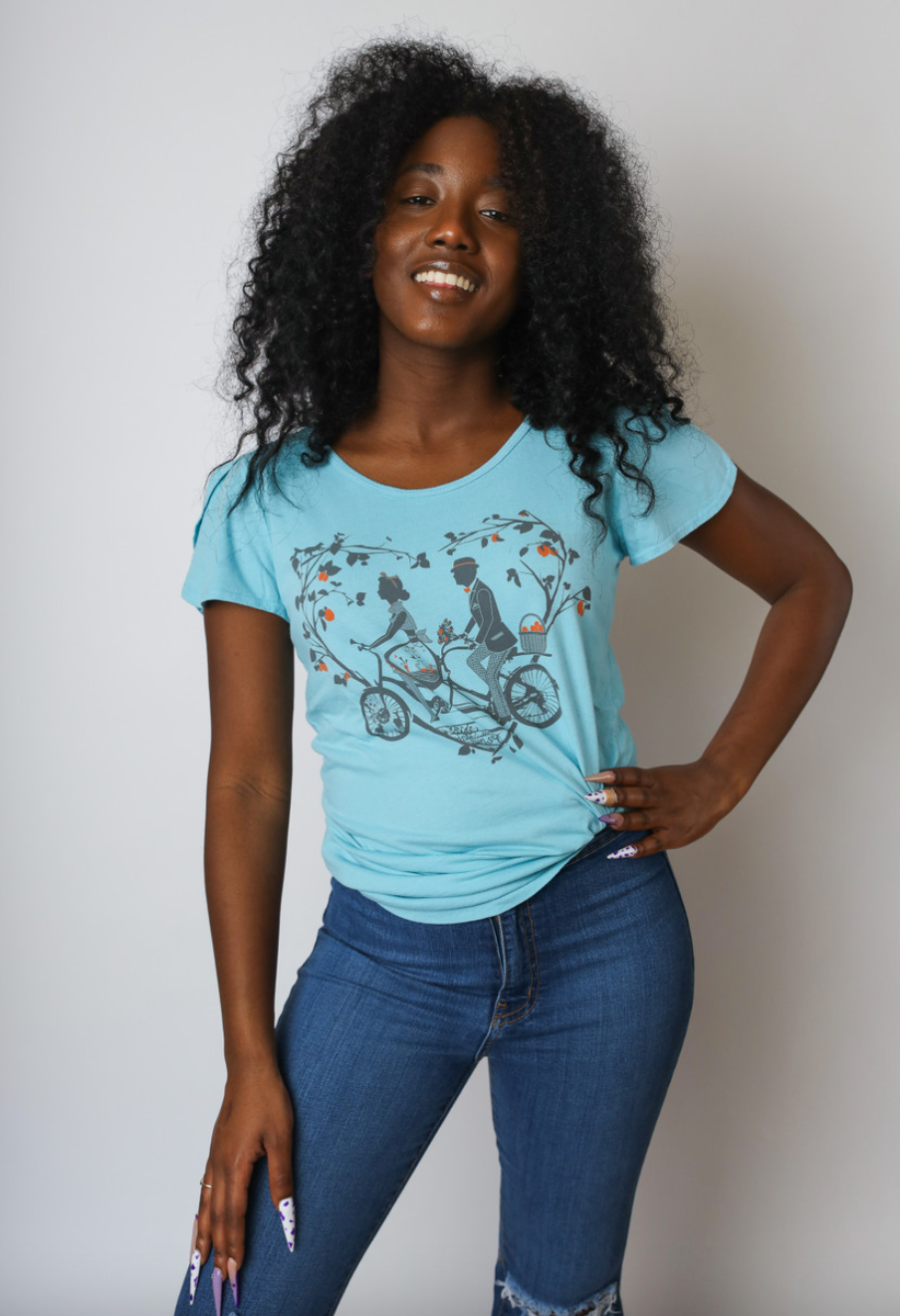 Sky blue tee with older couple riding tandem bicycle on African American model