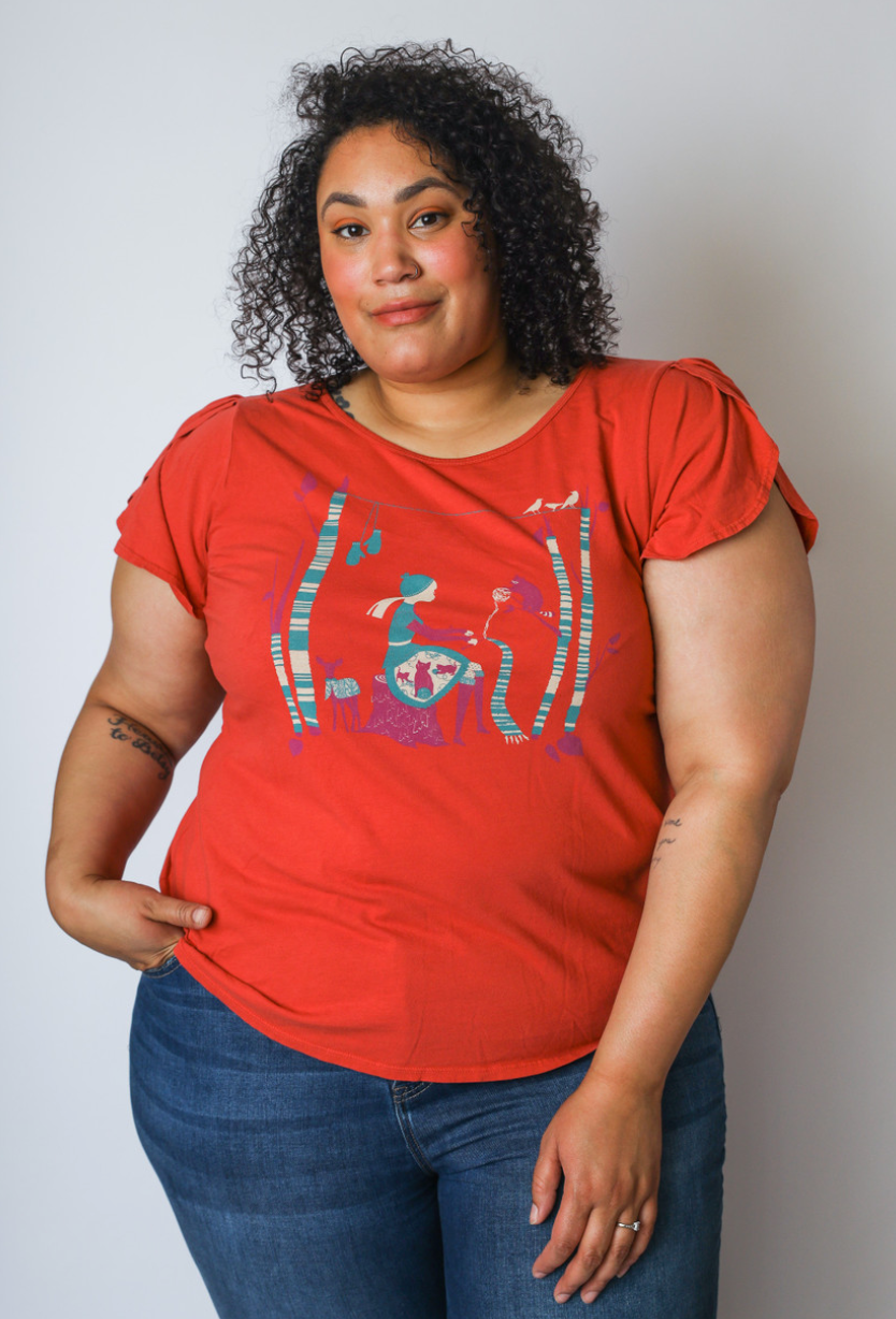 Curly haired model with red t-shirt with knitting girl graphic