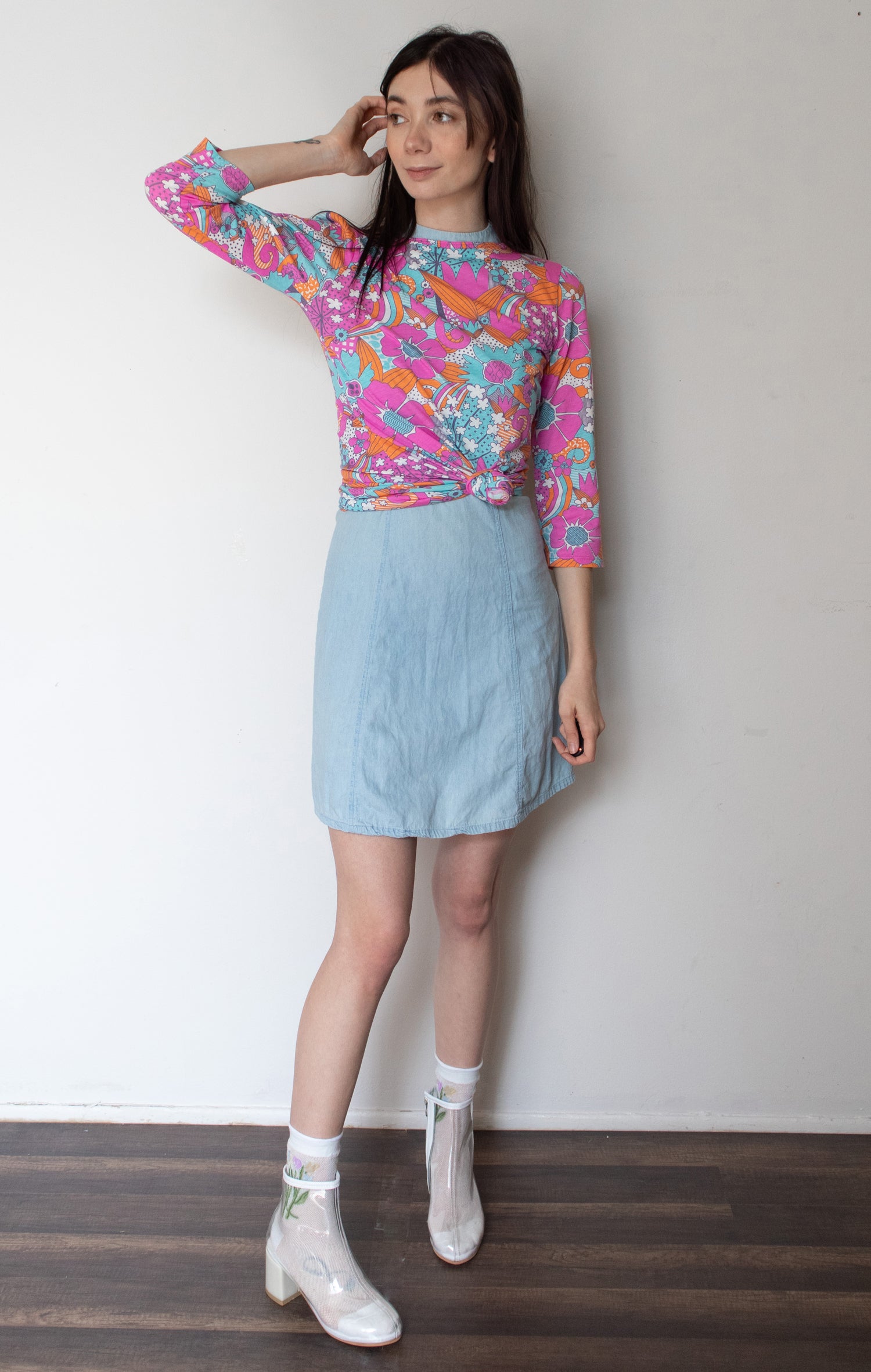 Bright pink, aqua and pink floral 3/4 sleeve cotton tee on model 