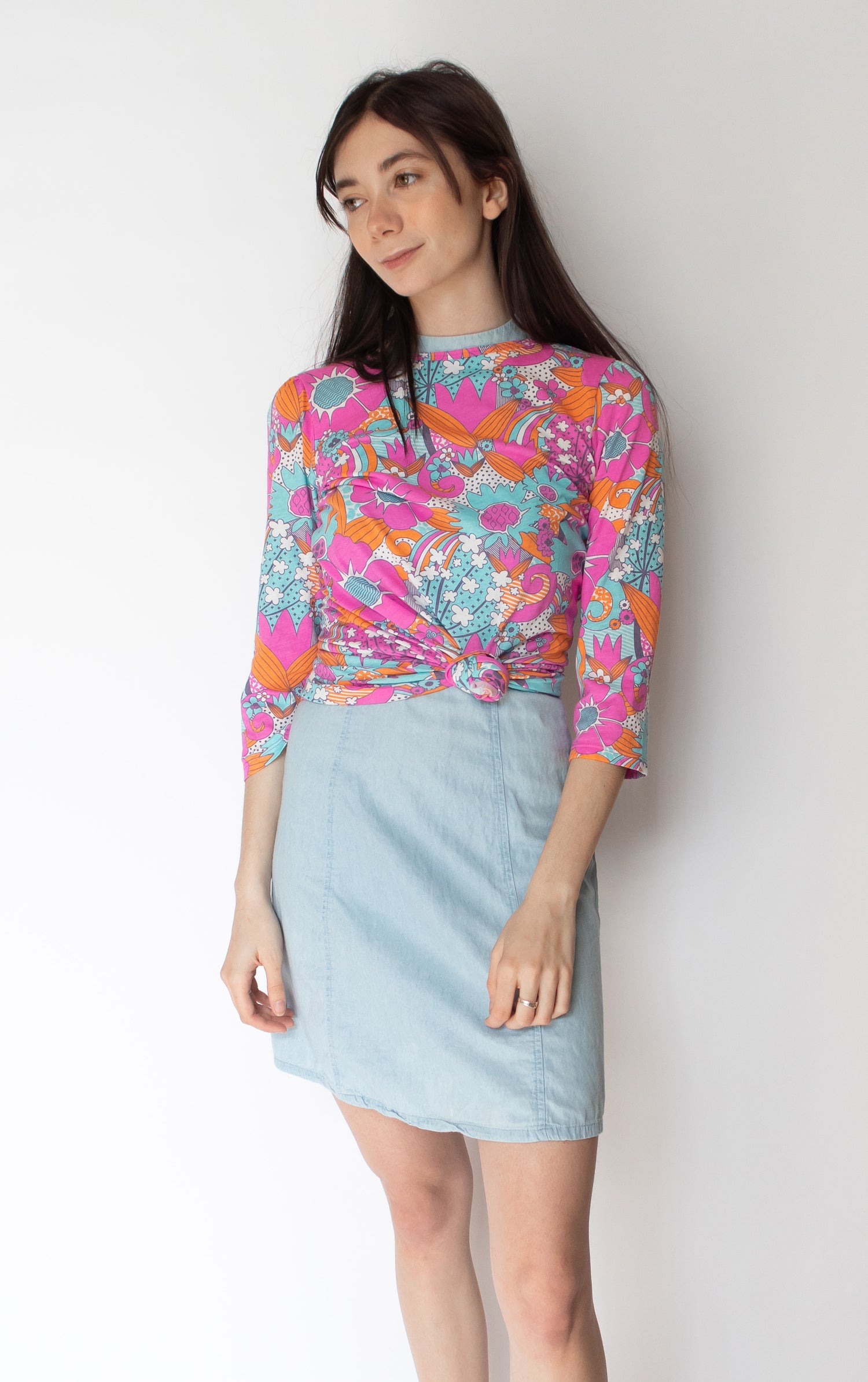 Bright pink, aqua and pink floral 3/4 sleeve cotton tee on model