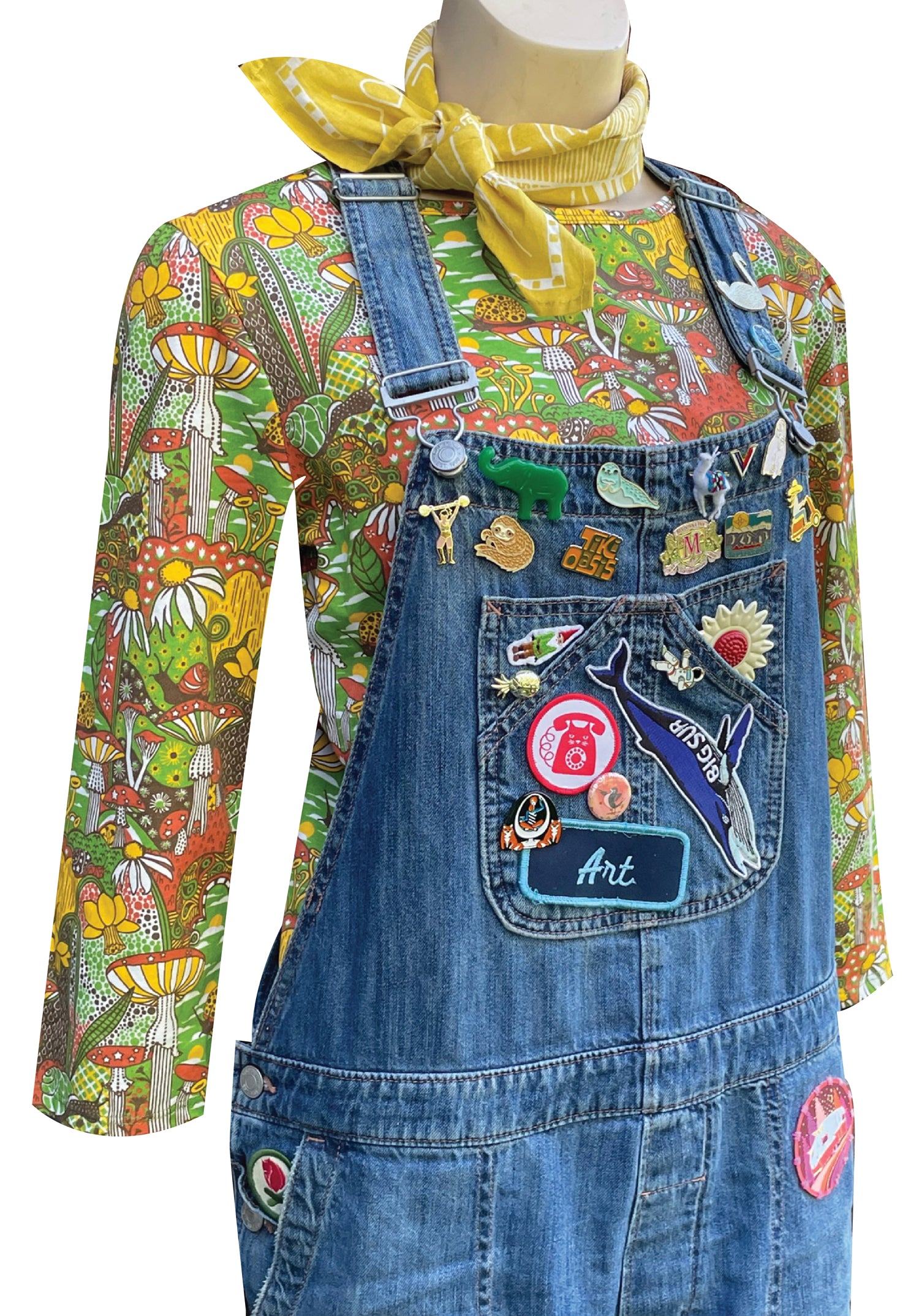 3/4 sleeve tee in green with fantastical landscape featuring mushrooms and blue jean overalls