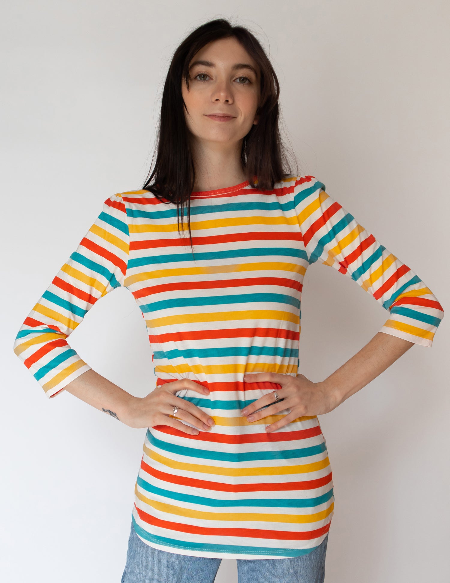 Striped, bright colored 3/4 sleeve tee worn untucked
