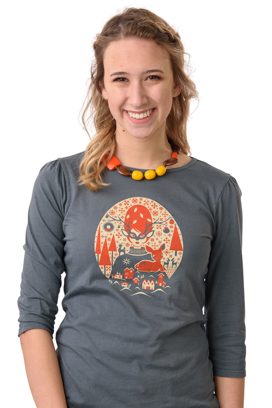 Blonde model wearing grey 1/2 sleeve shirt with graphic of orange haired woman in glasses with a baby deer