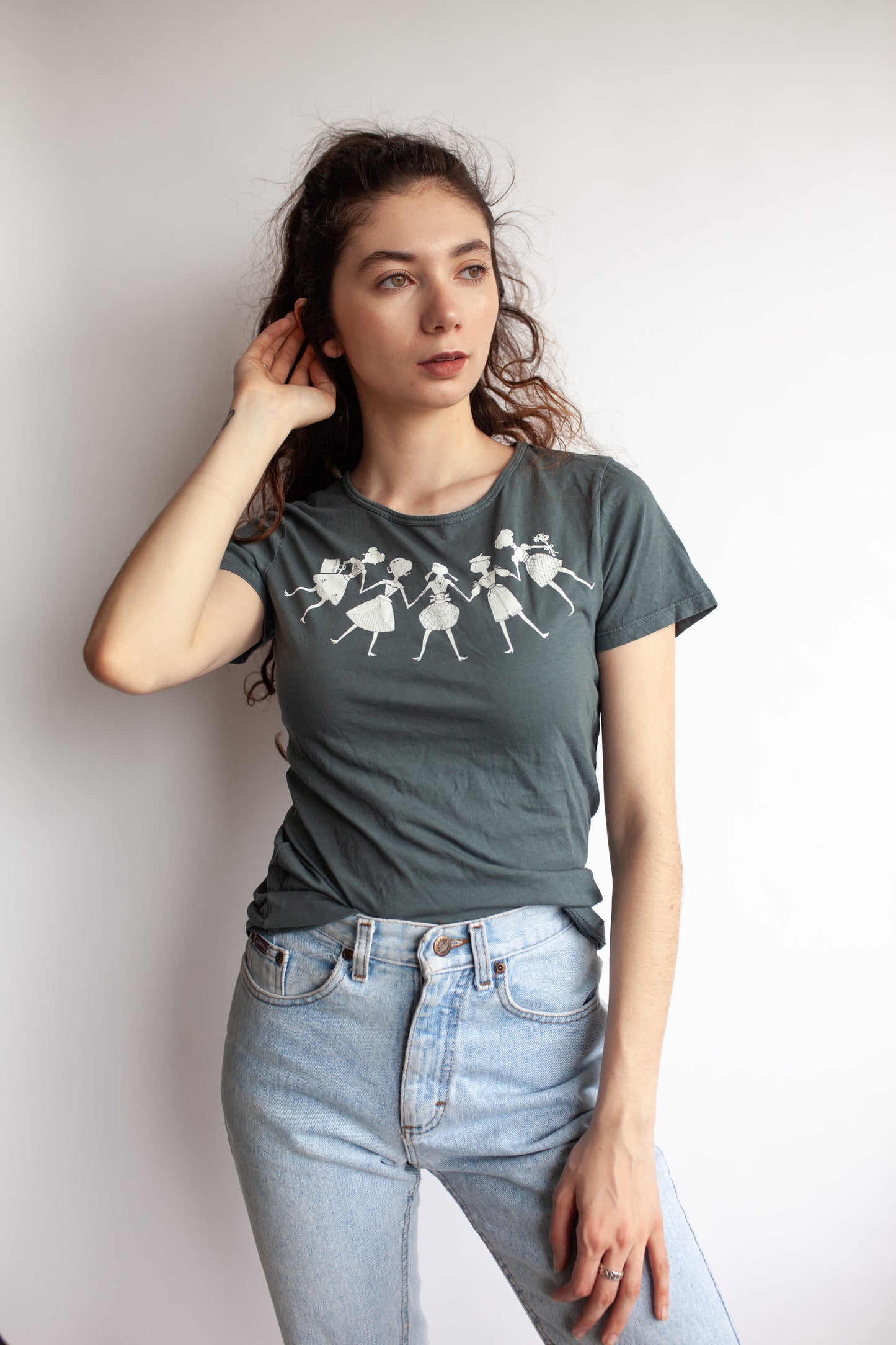 Model wearing cool grey tee featuring white paper dolls print 