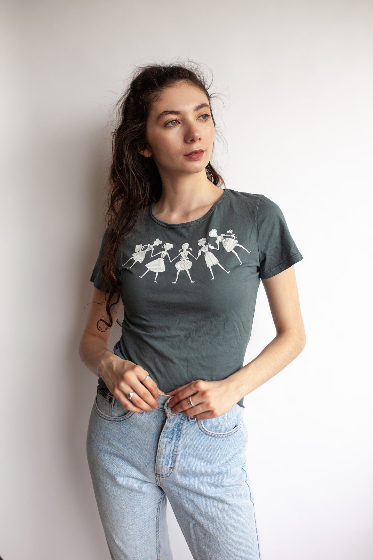 Model wearing cool grey tee featuring white paper dolls print 