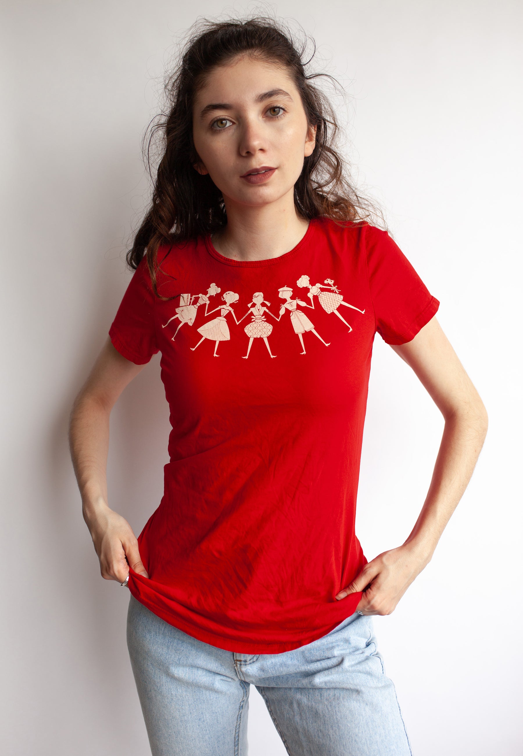Brunette model wearing red tee with women holding hands