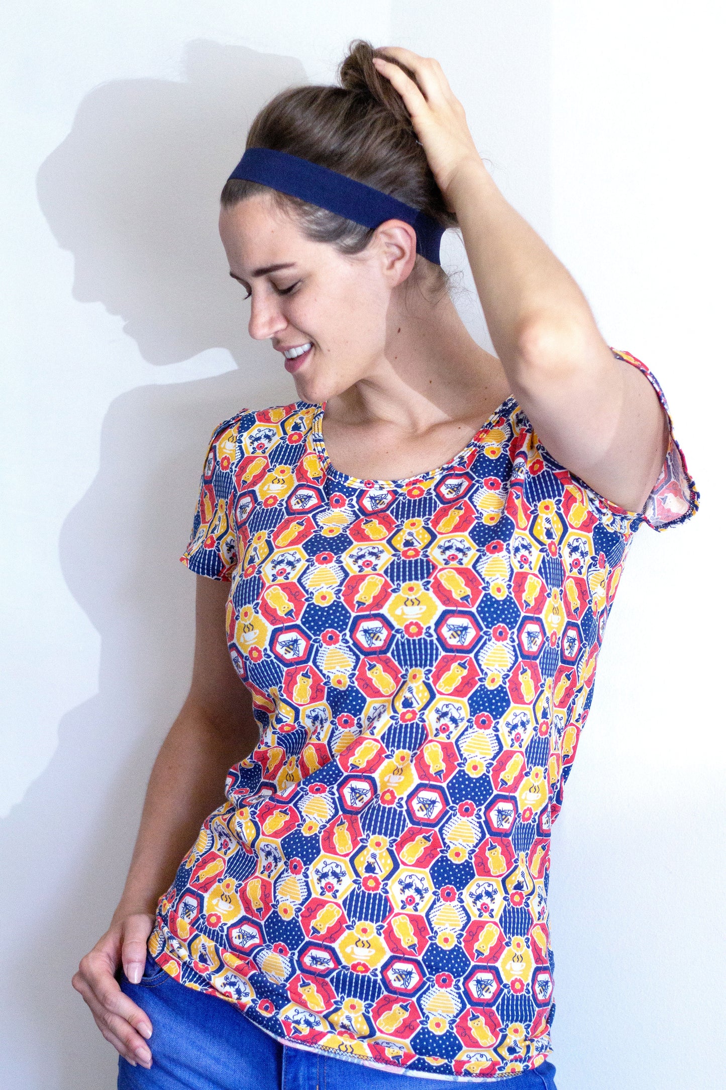 Blue, yellow and blue honeycomb, bee and flower print tulip-sleeved tee on model 