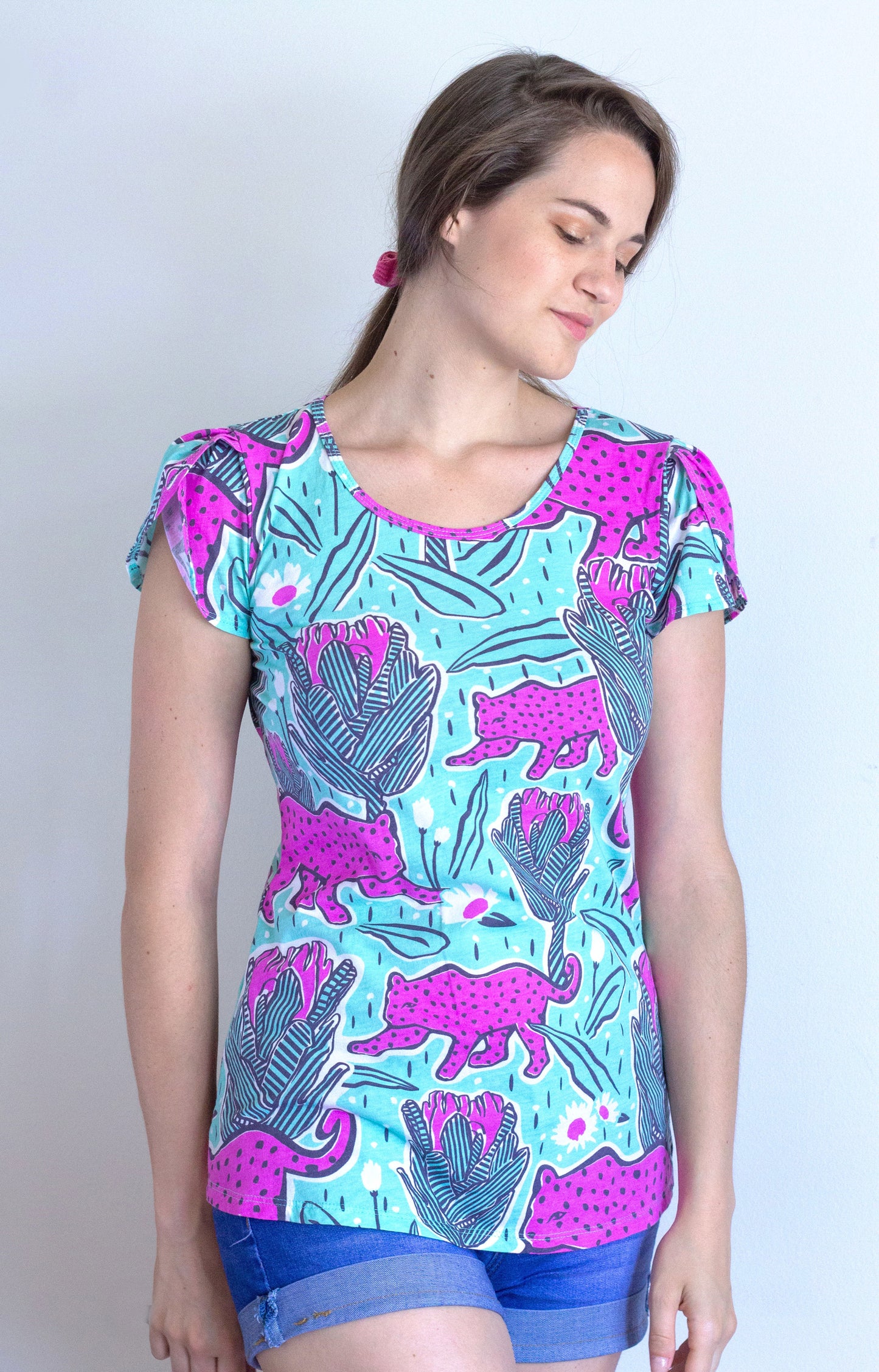 Mint green and orchid pink tulip-sleeved tee with jaguars and tropical flowers