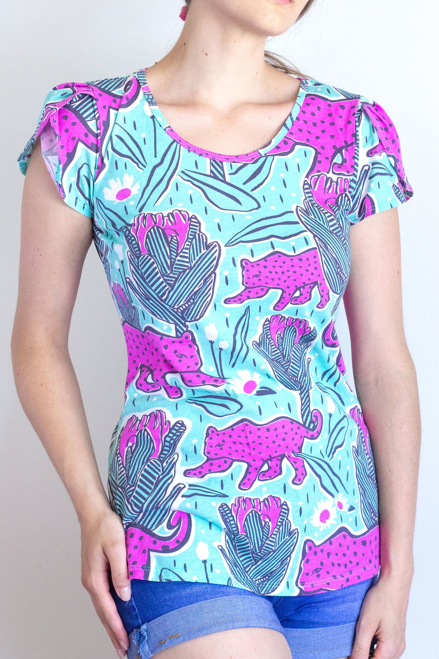 Mint green and orchid pink tulip-sleeved tee with jaguars and protea flowers