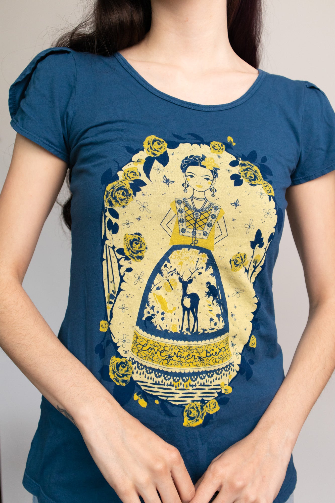 Navy blue tulip-sleeved tee with yellow and blue screen print of an artist woman, deer, and roses