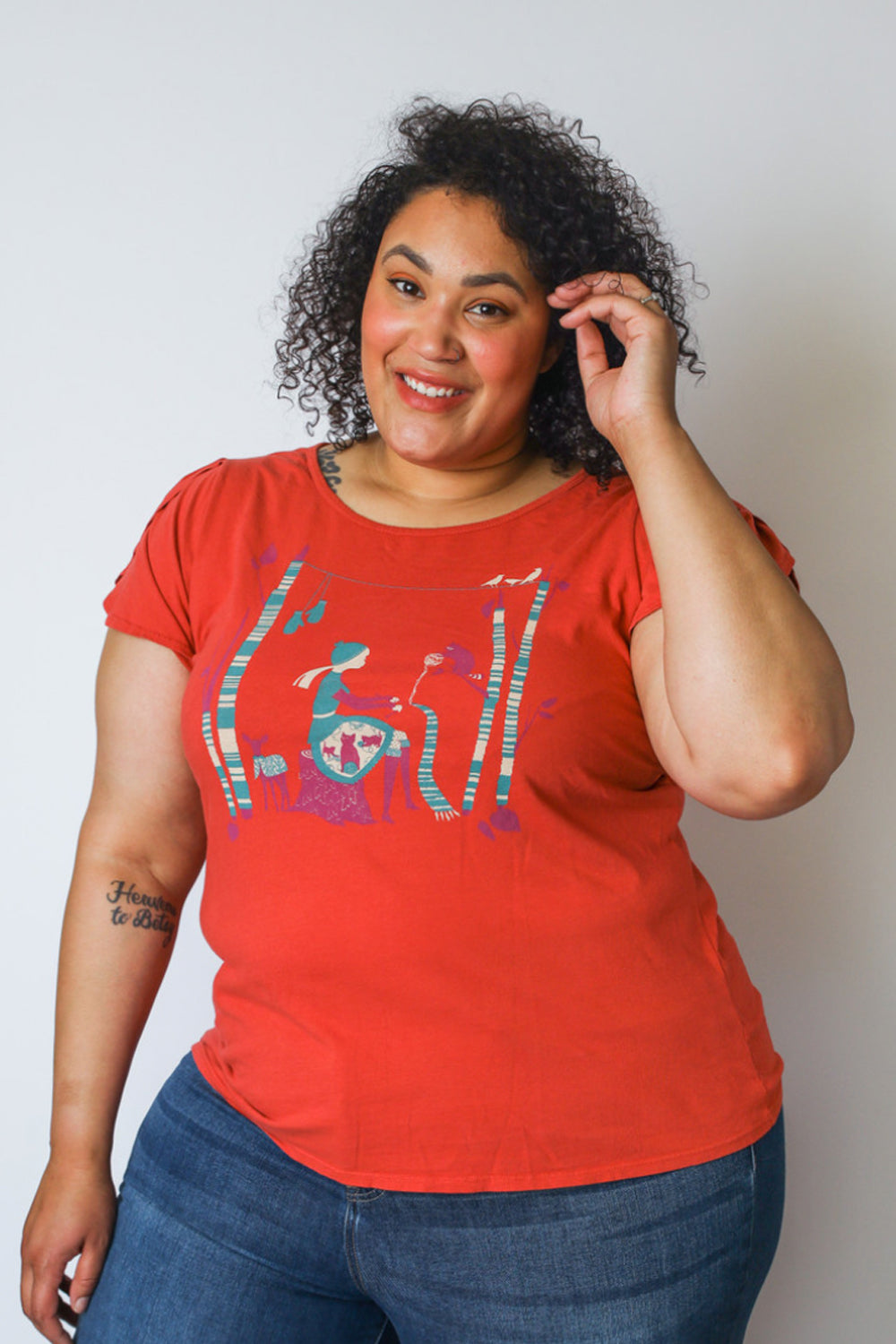 Curly haired model with red t-shirt with knitting girl graphic