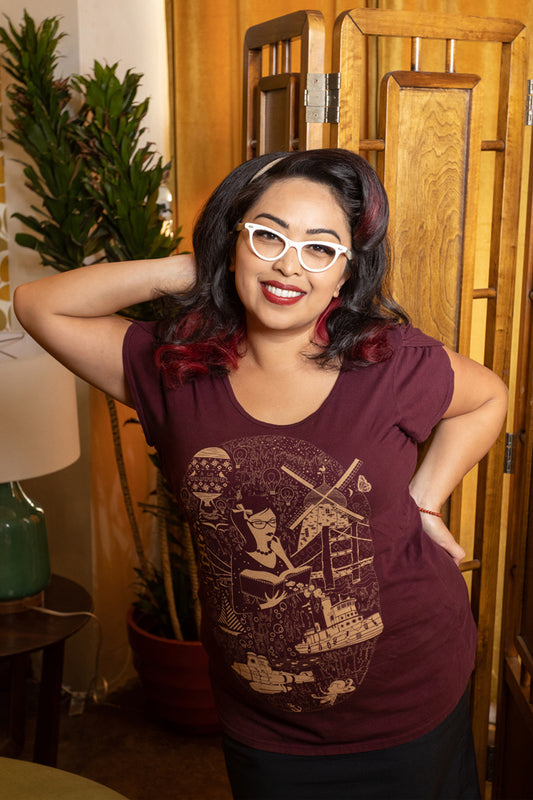 Young woman in plum colored tee with librarian print