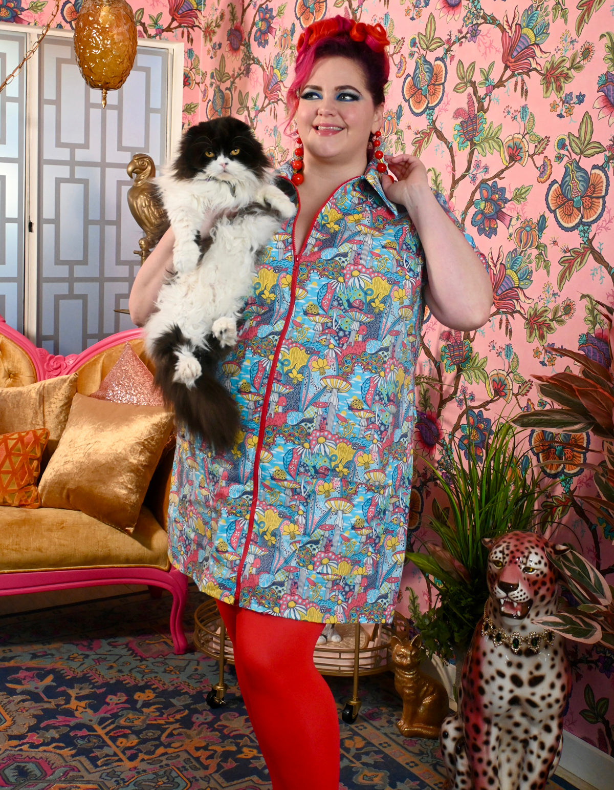 Red-haired model holding cat wearing mushroom print zip-front collared minidress