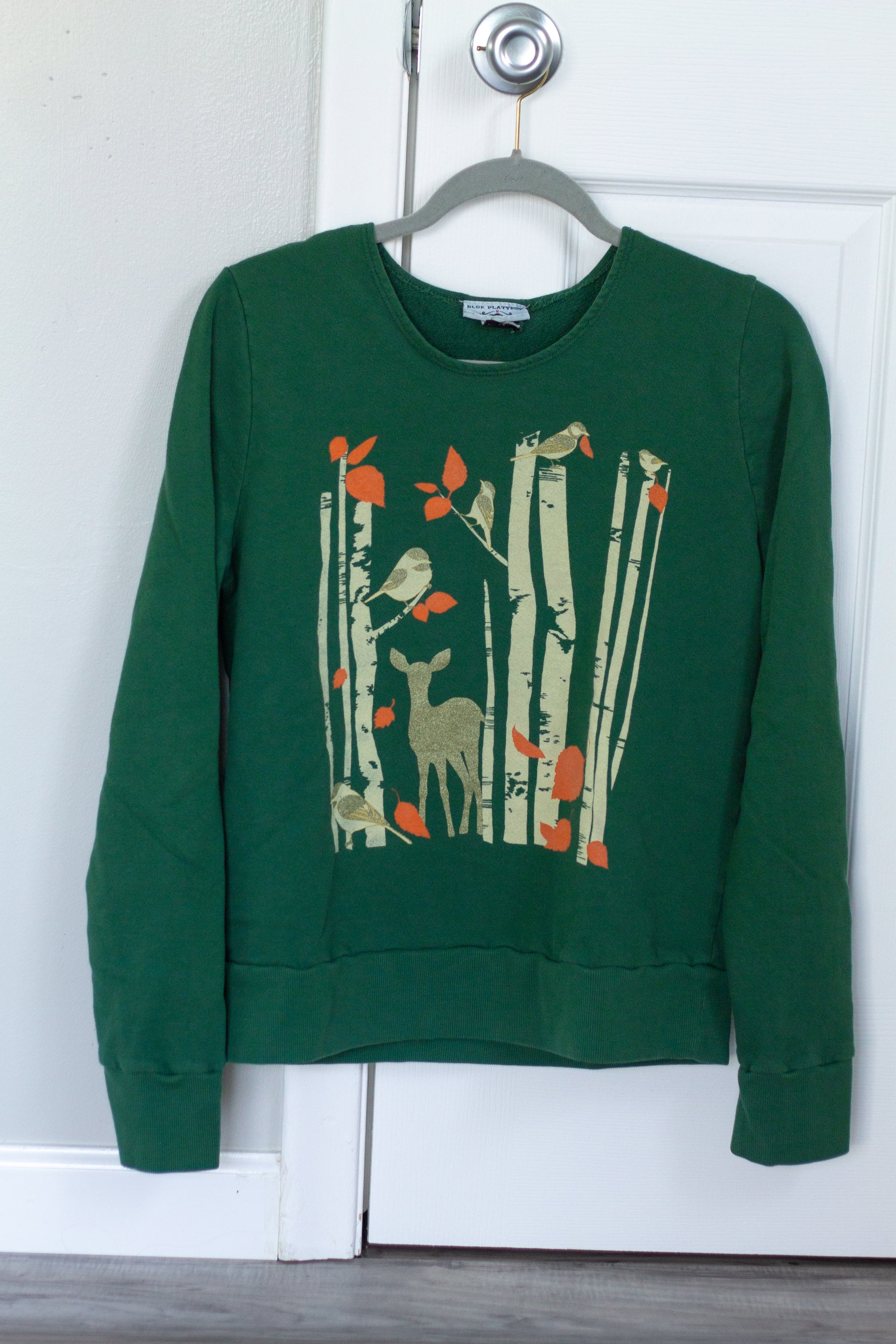 Dark green sweatshirt with screen print of birch trees, leaves, birds and deer