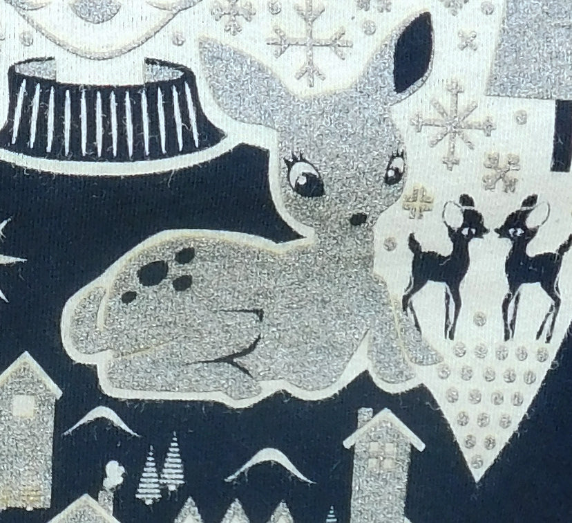 Closeup of sparkly gold reindeer from black Christmas shirt