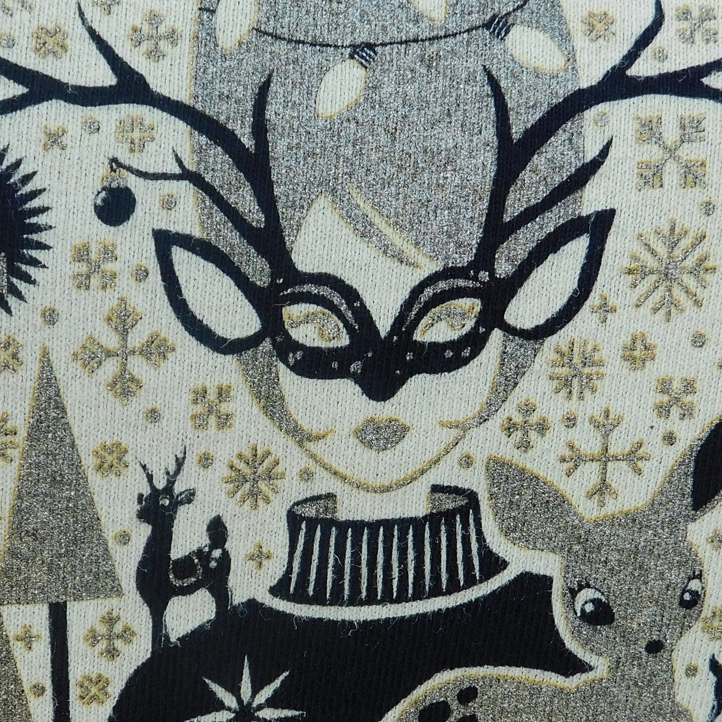 Closeup of gold, black and white masked girl print