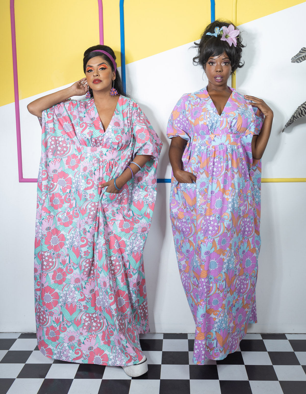 2 tall women posing in flower print caftans with pockets