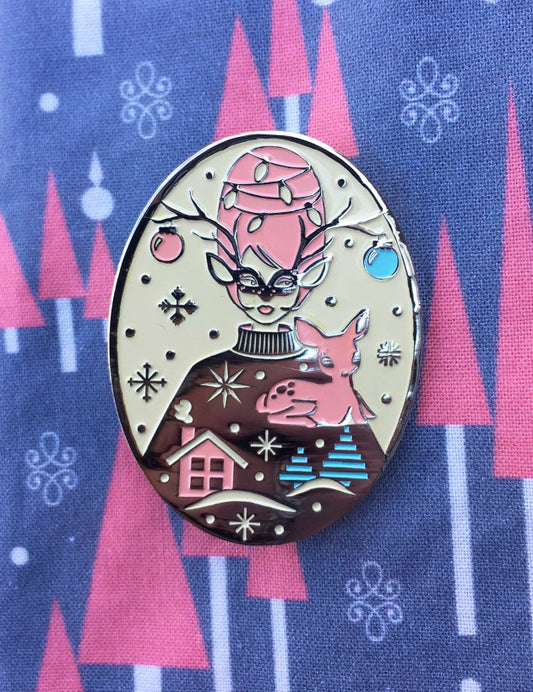 Pink, silver, off-white and mint green enamel pin with masked girl with beehive hair and reindeer