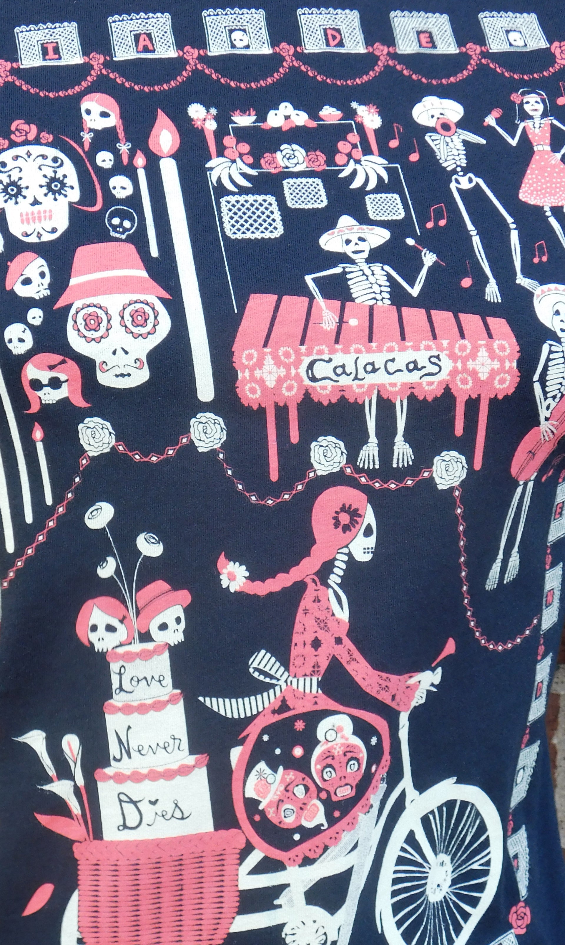 Close up of print featuring skeletons at a celebration