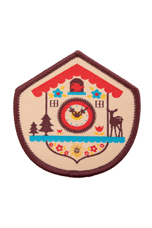 Brown red yellow and blue woven patch with a Bavarian cuckoo clock and brown border