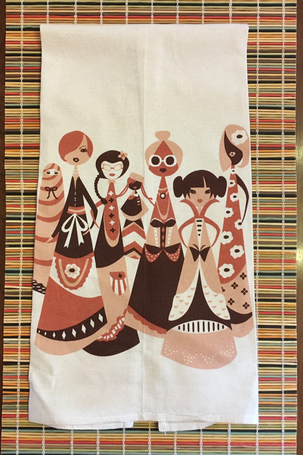 A dish towel featuring a variety of women