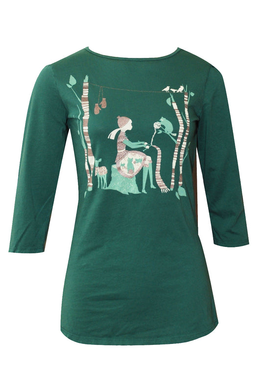 Pine green tee with print of knitting girl surrounded by animals in the woods