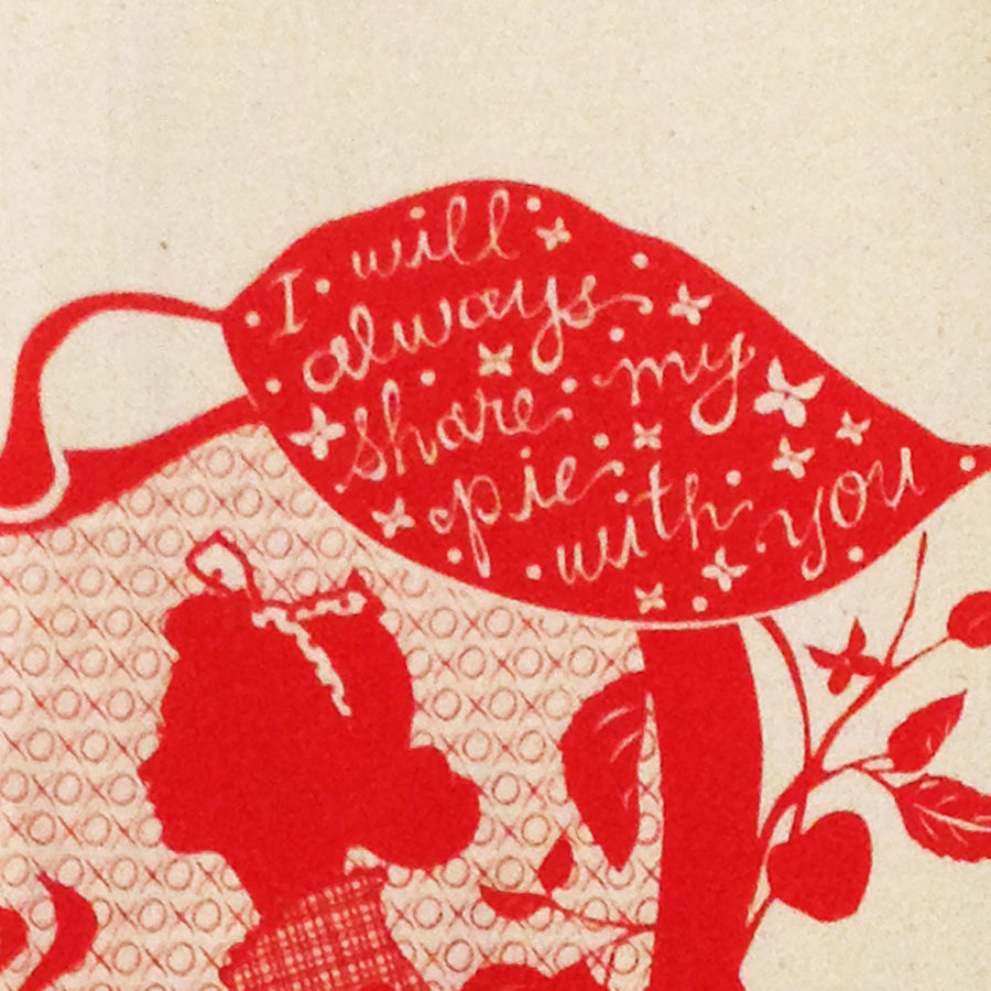 Closeup of love and pie design on red and off-white tea towel