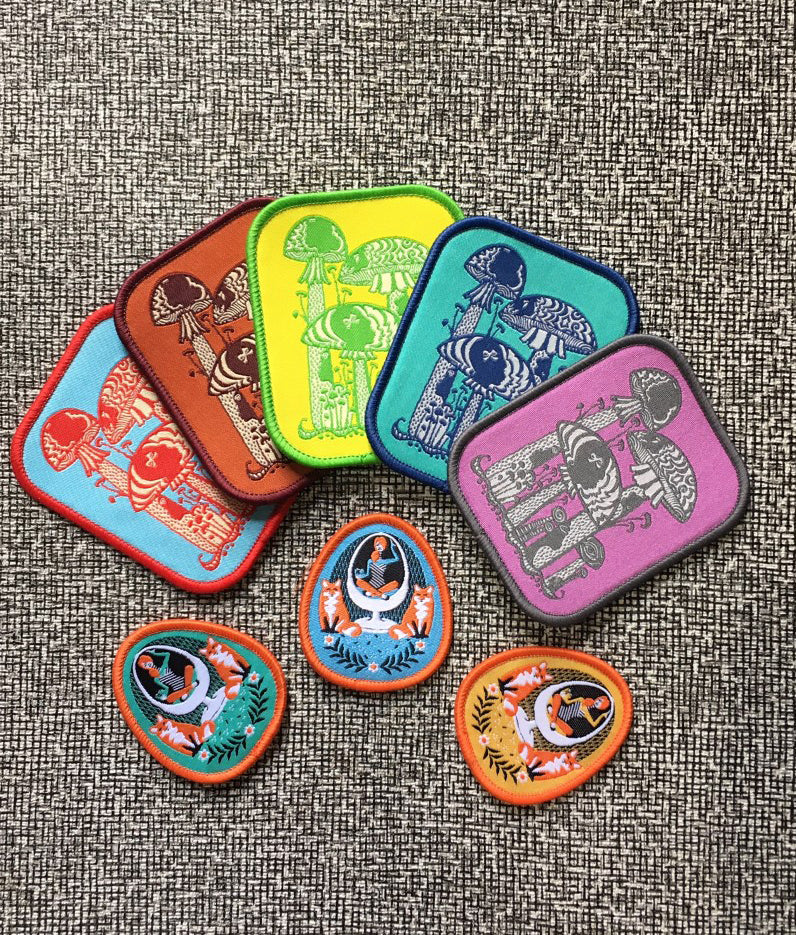 Several colorful iron on patches with mushrooms and foxes 