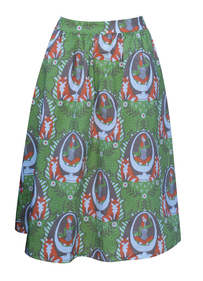 Olive green and orange gathered midi skirt with print of girl reading in egg chair with foxes and big orange zip