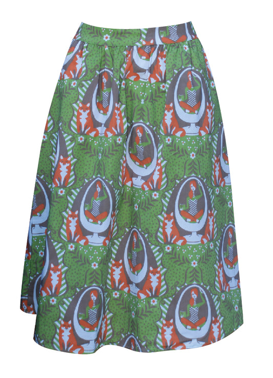 Olive green and orange gathered midi skirt with print of girl reading in egg chair with foxes and big orange zip