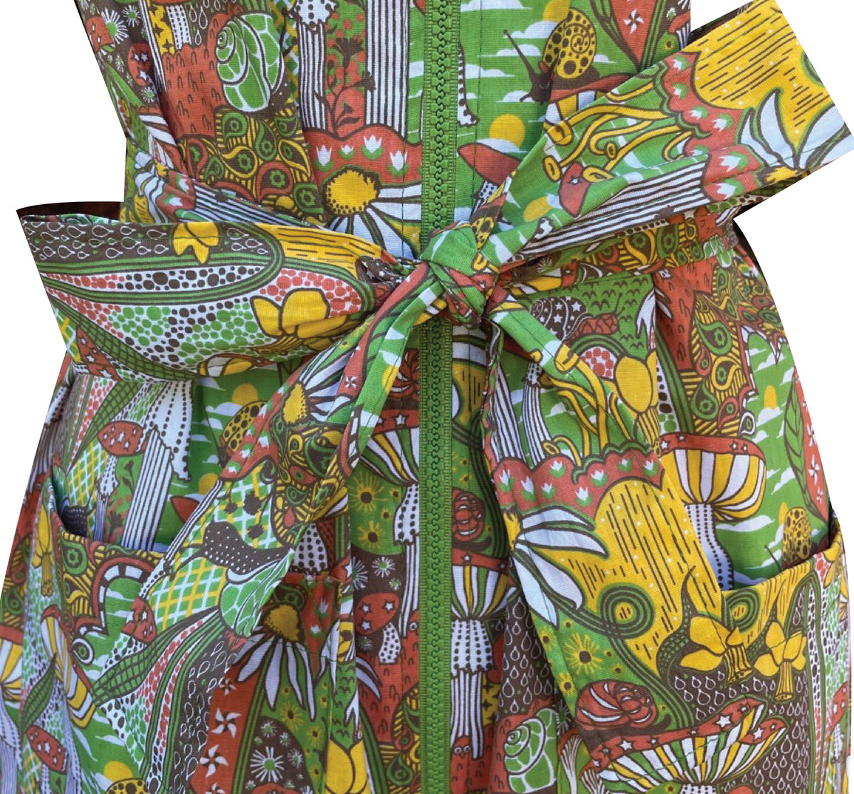 Closeup of green and yellow mushroom print tie belt and front zipper 