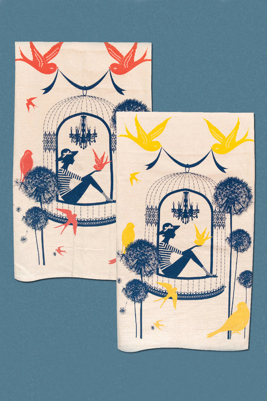 2 cotton tea towels with a woman in a birdcage surrounded by birds and flowers