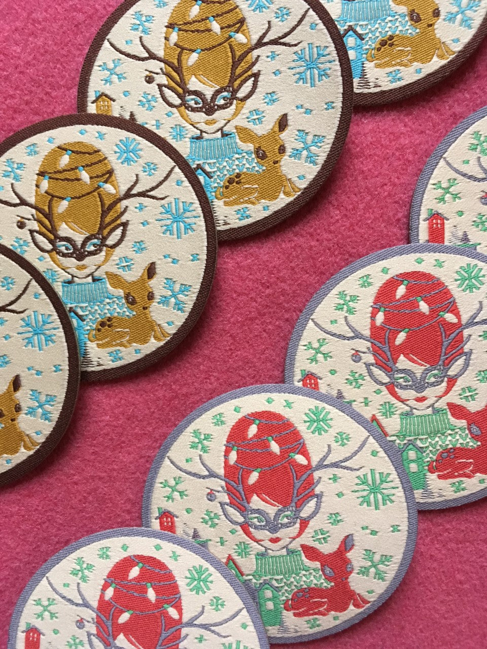 2 rows of colorful holiday themed iron on patches with reindeer and snowflakes